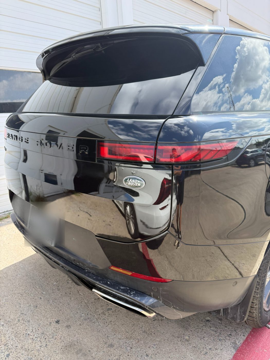 Range Rover rear quarter refinished in clean gloss black with no visible transition