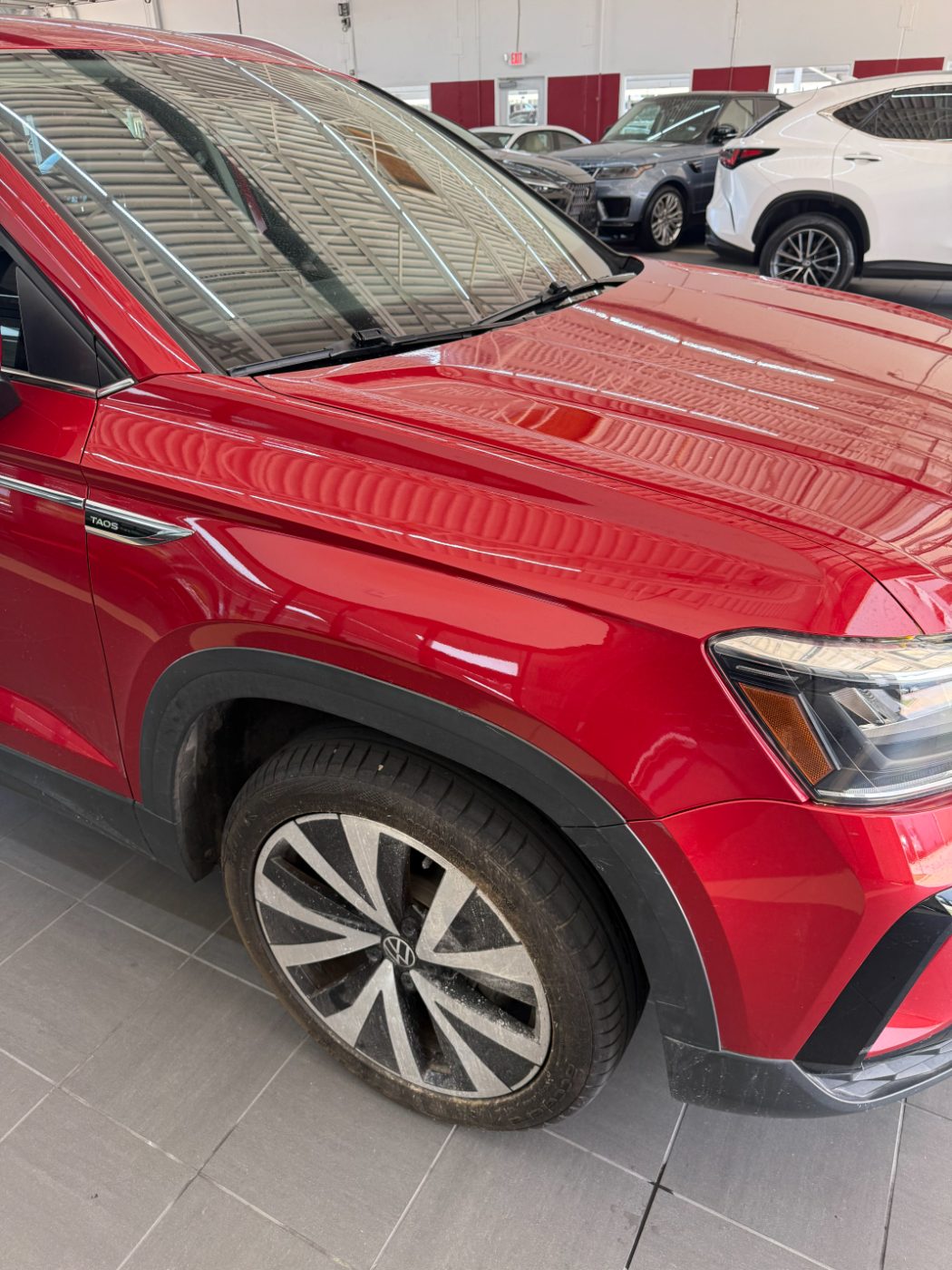 The same Volkswagen Taos after fender repair, the panel straight and the finish matched.