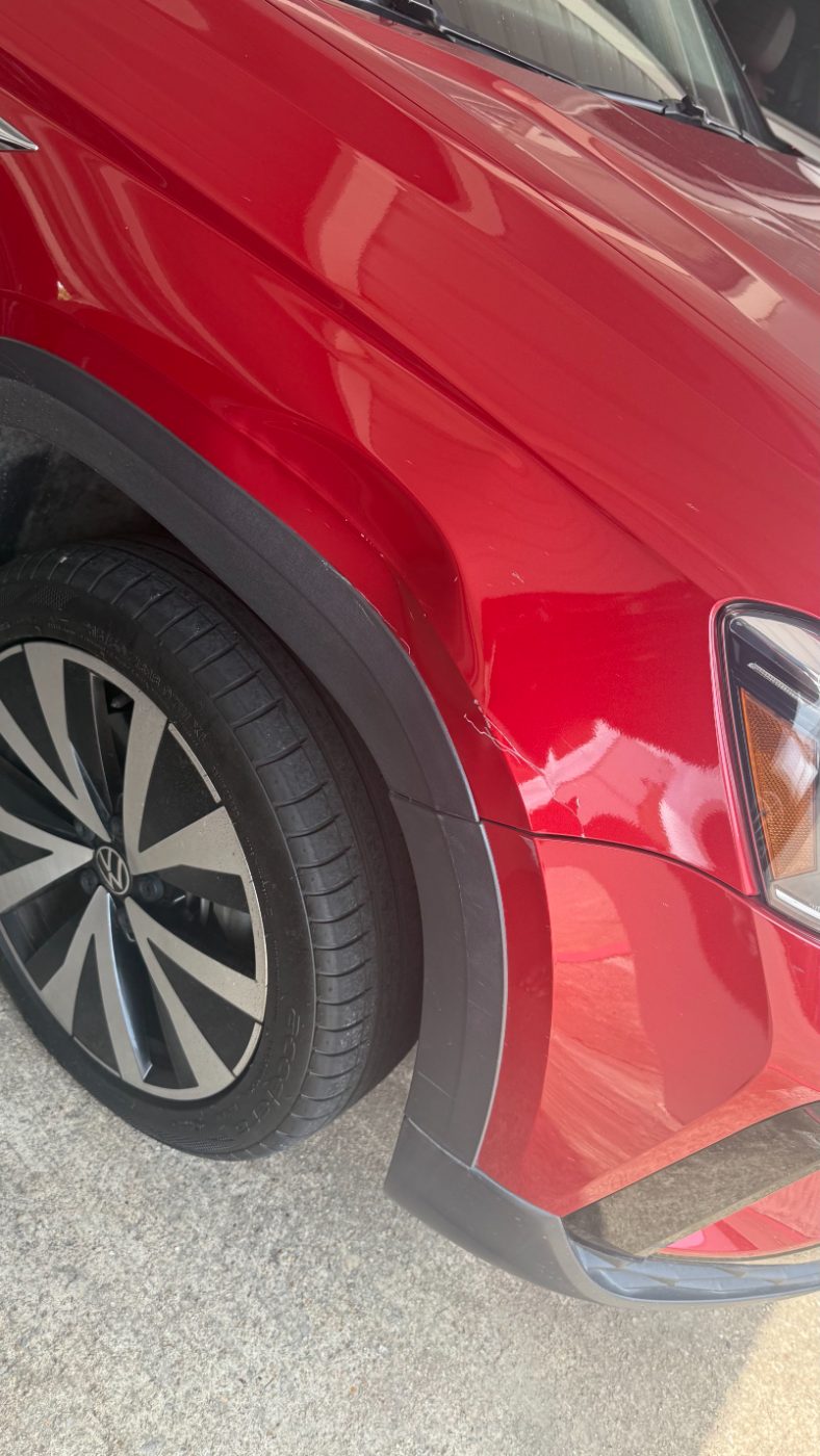 Volkswagen Taos with a damaged fender before repair at our Plano shop.