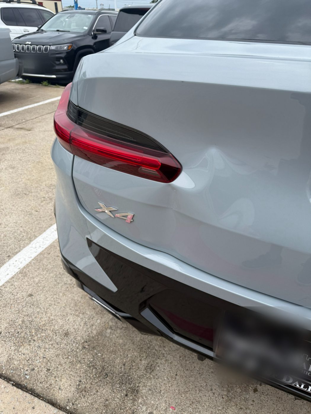 BMW X4 with damaged bodywork before repair at our Plano shop.