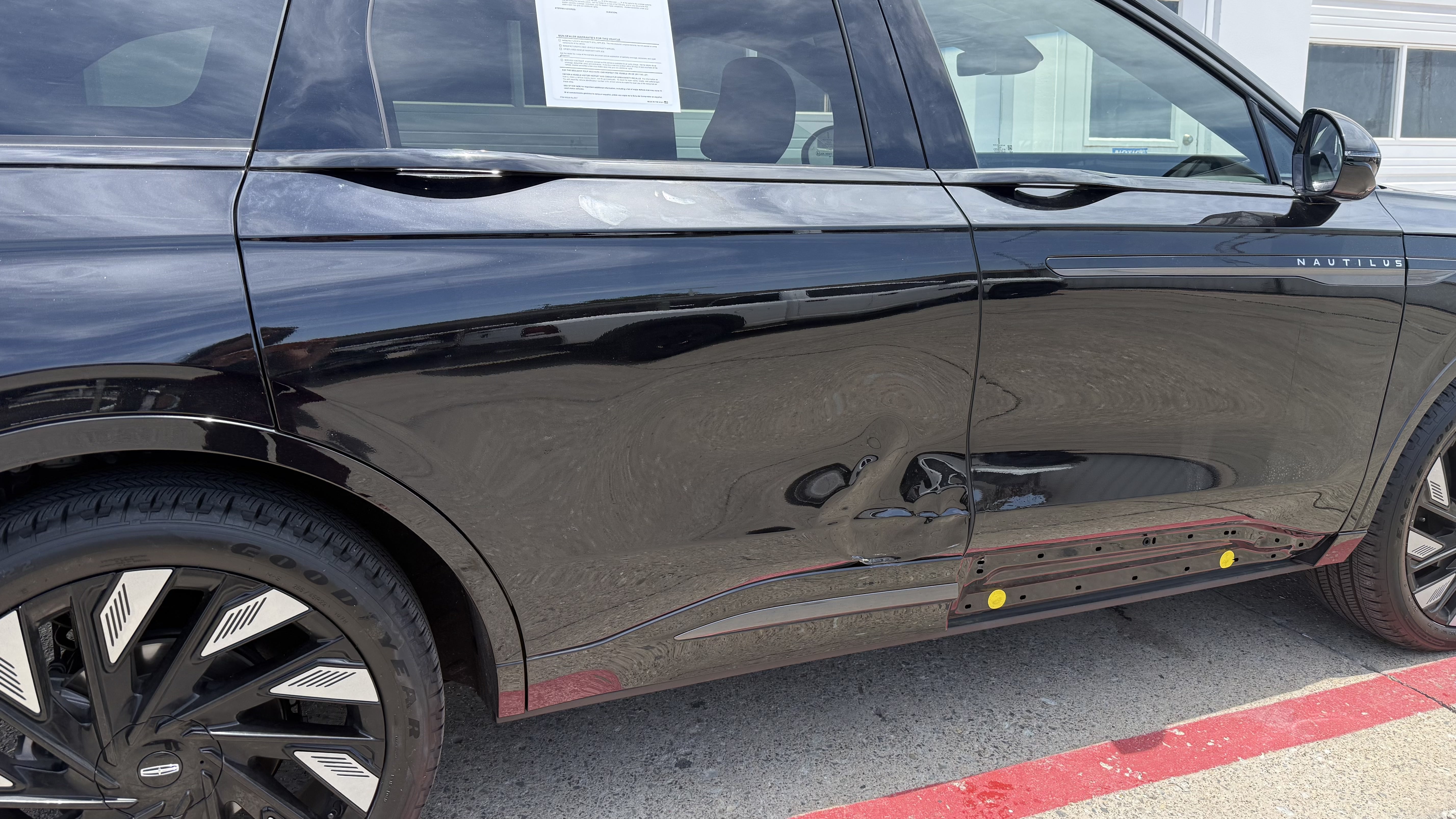 Lincoln Nautilus with crushed driver door and rocker panel stripped to primer
