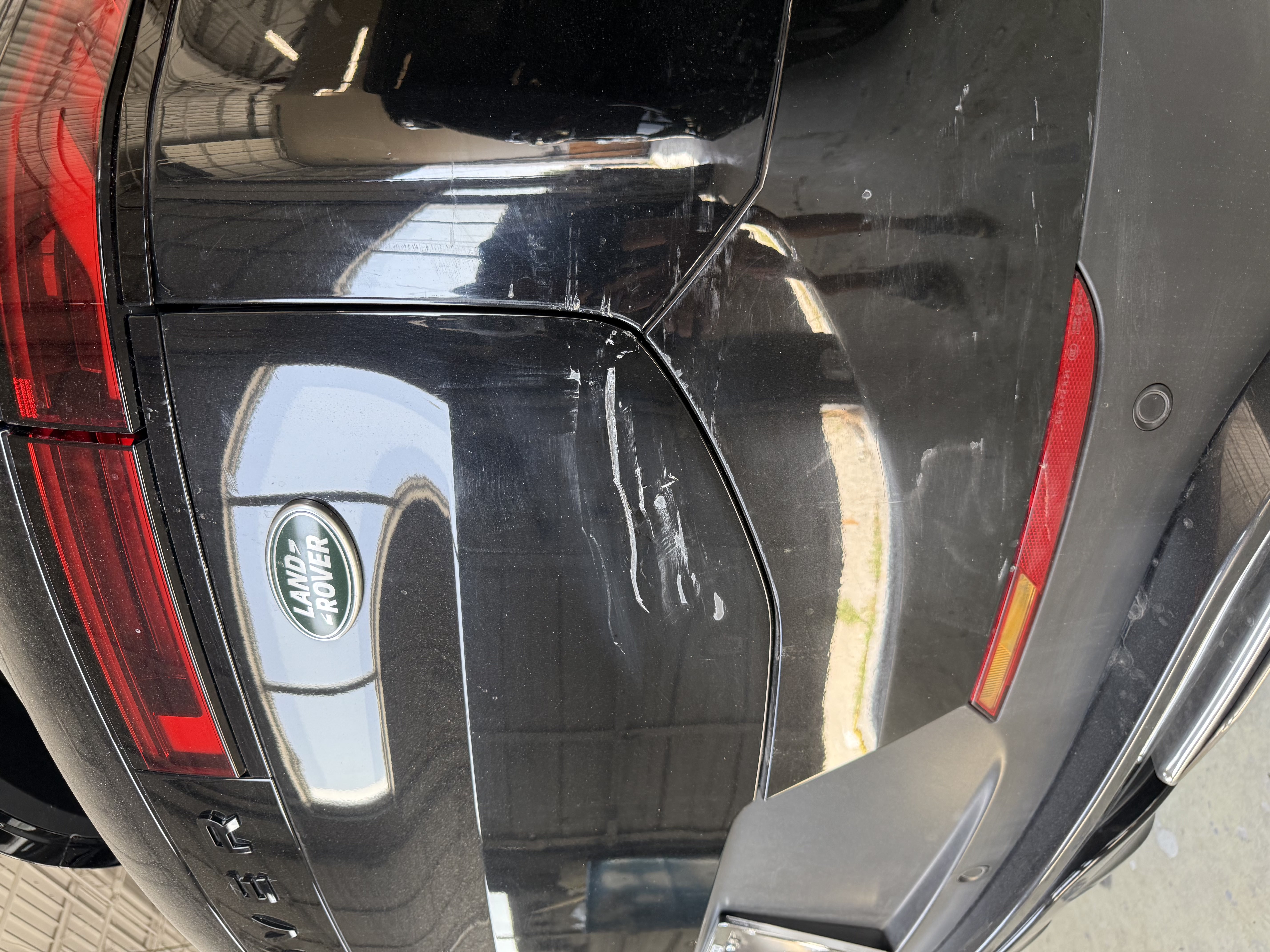 Range Rover rear quarter with deep scrape across the tailgate seam